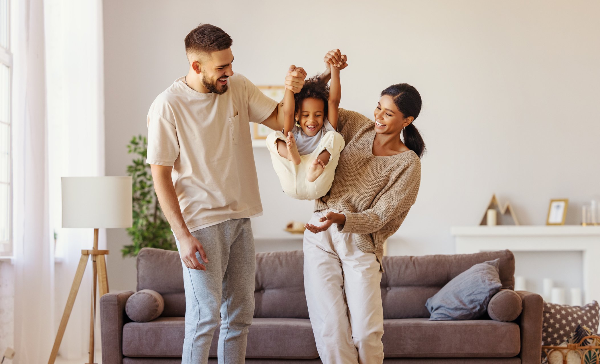 Diverse family playing near sofa